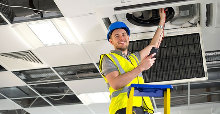 HVAC technician repairing HVAC unit